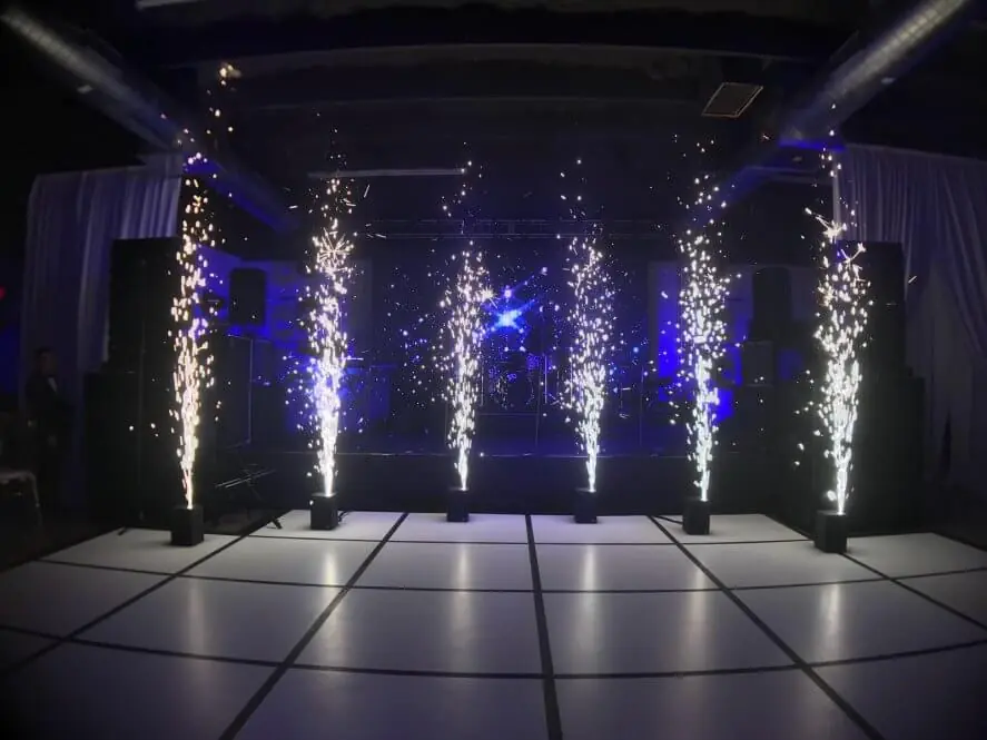 Row of cold spark machines firing fountains of sparks across a dance floor