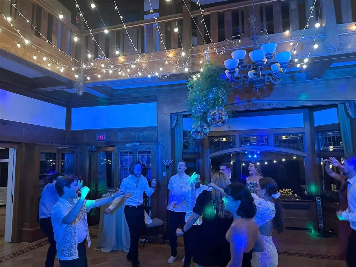 Guests dancing under string lights and disco balls at a Presto event