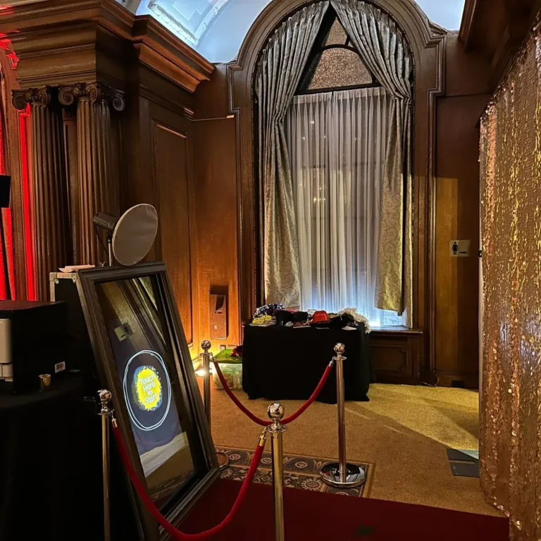 Magic Mirror photo booth with red carpet and gold sequin backdrop at an elegant venue