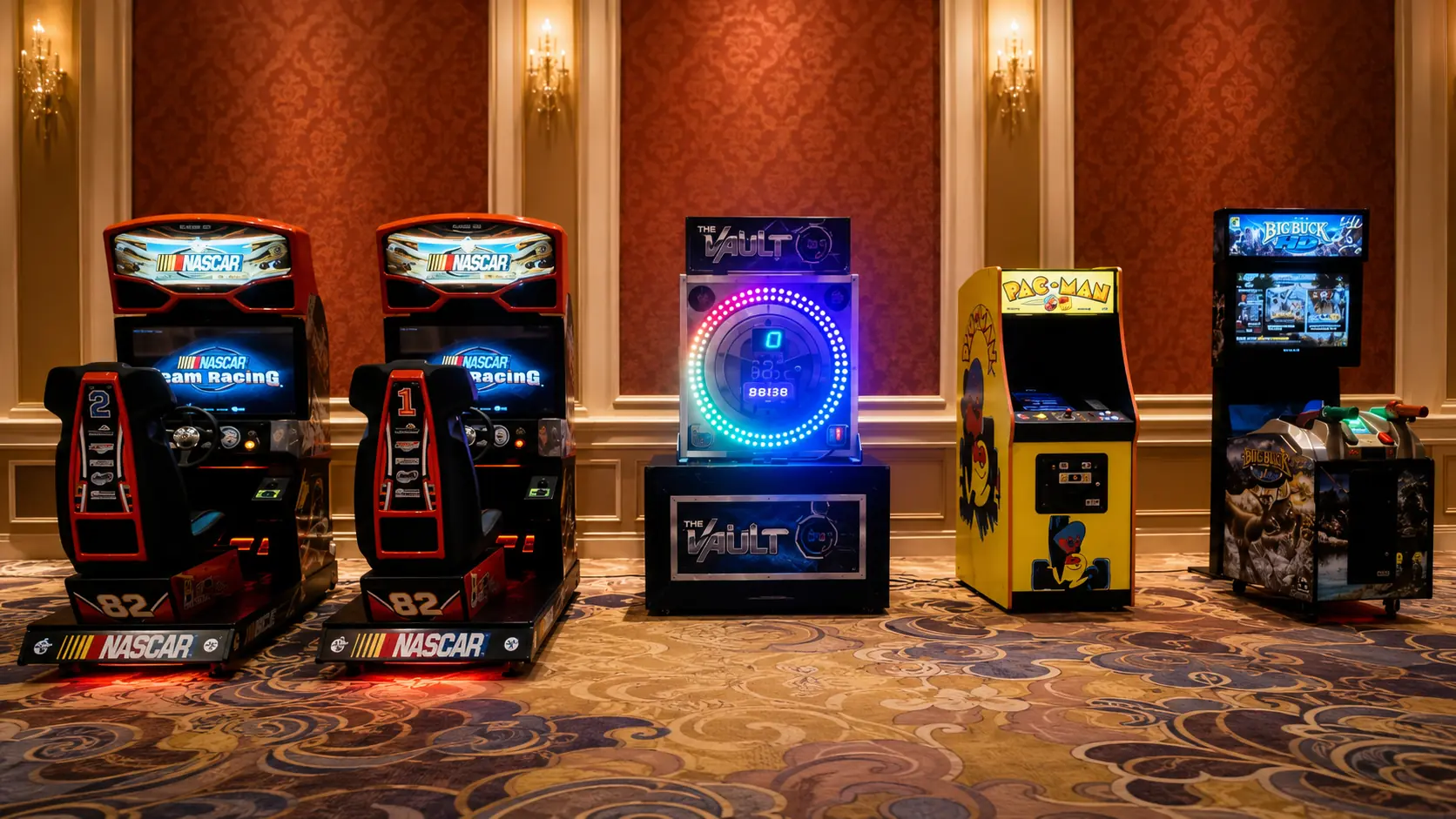 Row of classic arcade and racing game cabinets set up in a ballroom