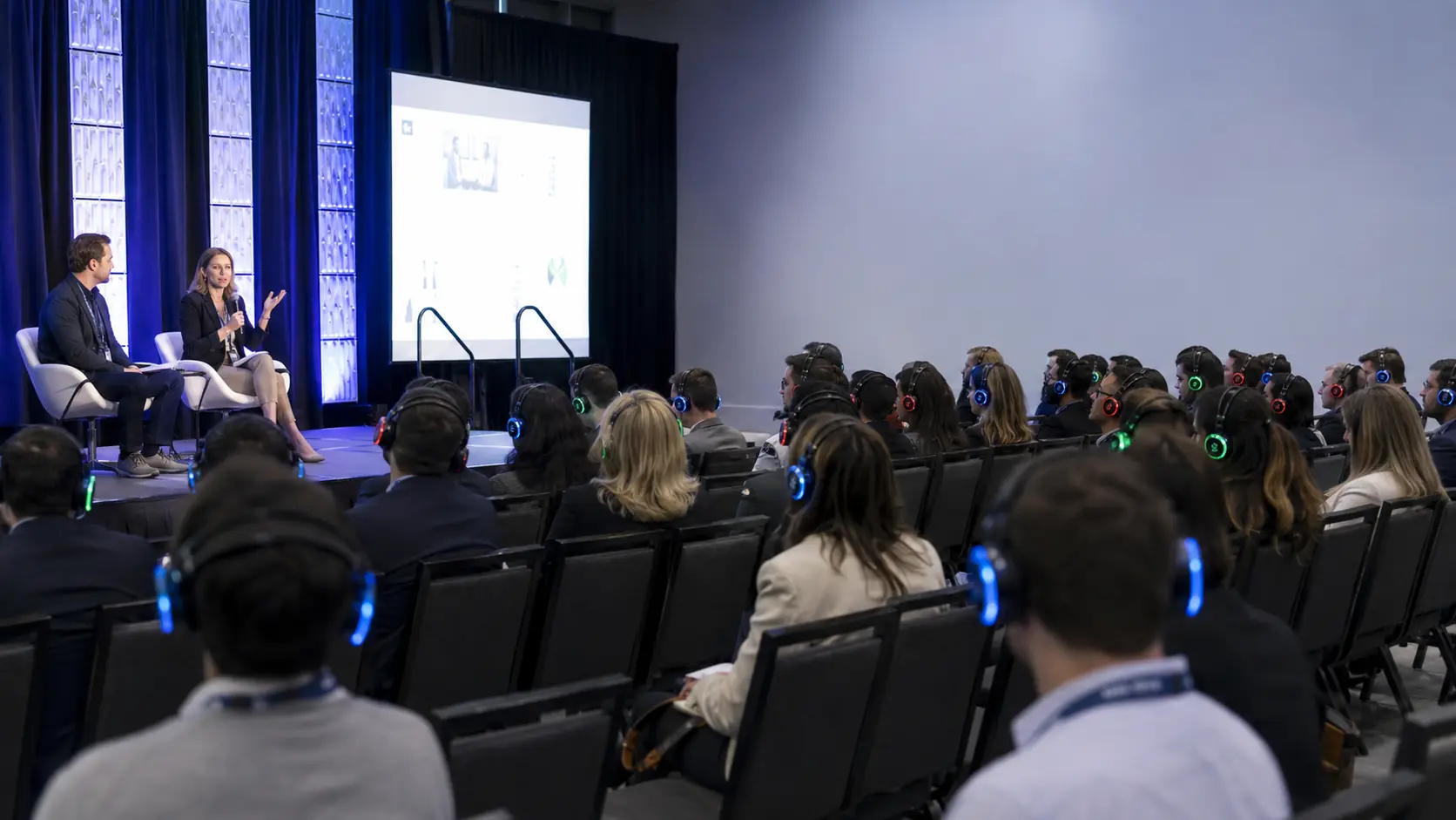 Corporate conference audience wearing wireless silent disco headsets